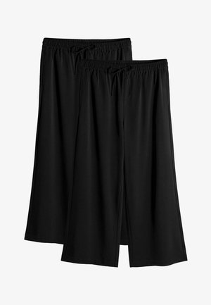 Två par svarta vida byxor gjorda av ett mjukt tyg. De har ett elastiskt midjeband med dragsko, vilket ger en avslappnad passform.