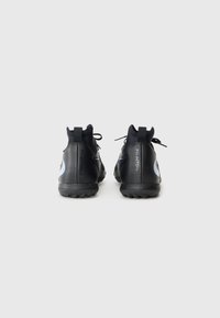 Black athletic shoes with a sleek design, textured rubber sole, and blue accents. Features a high ankle collar and laces for secure fit.
