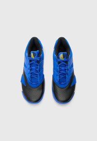 Blue athletic shoes with a black textured sole, featuring mesh and synthetic materials, flat laces, and a yellow logo accent on the side.
