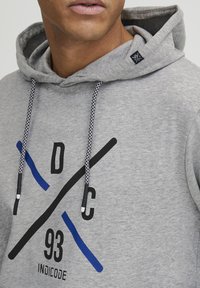 Gray hoodie with a drawstring featuring black and blue graphic designs. Made of soft fabric, it has a kangaroo pocket and ribbed cuffs.
