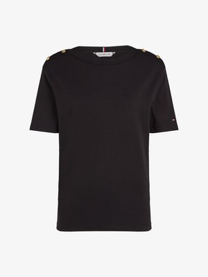 Black short-sleeve t-shirt made of cotton. Features gold button accents on shoulders and a round neckline with a branded tag visible inside.
