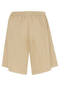 Beige shorts med elastisk midja, tillverkade av ett lätt tyg och med en lös, bred design som faller till mitten av låret.