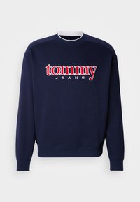 Námornícky modrá mikina s veľkým červeným a bielym logom "tommy" a textom "JEANS", s rebrovaným okrúhlym výstrihom a manžetami, vyrobená z mäkkej bavlnenej zmesi.