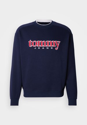 Bluză sport bleumarin cu un logo mare "tommy" roșu și alb și textul "JEANS", guler rotund cu tivuri striate, mâneci și tivuri dintr-un amestec moale de bumbac.