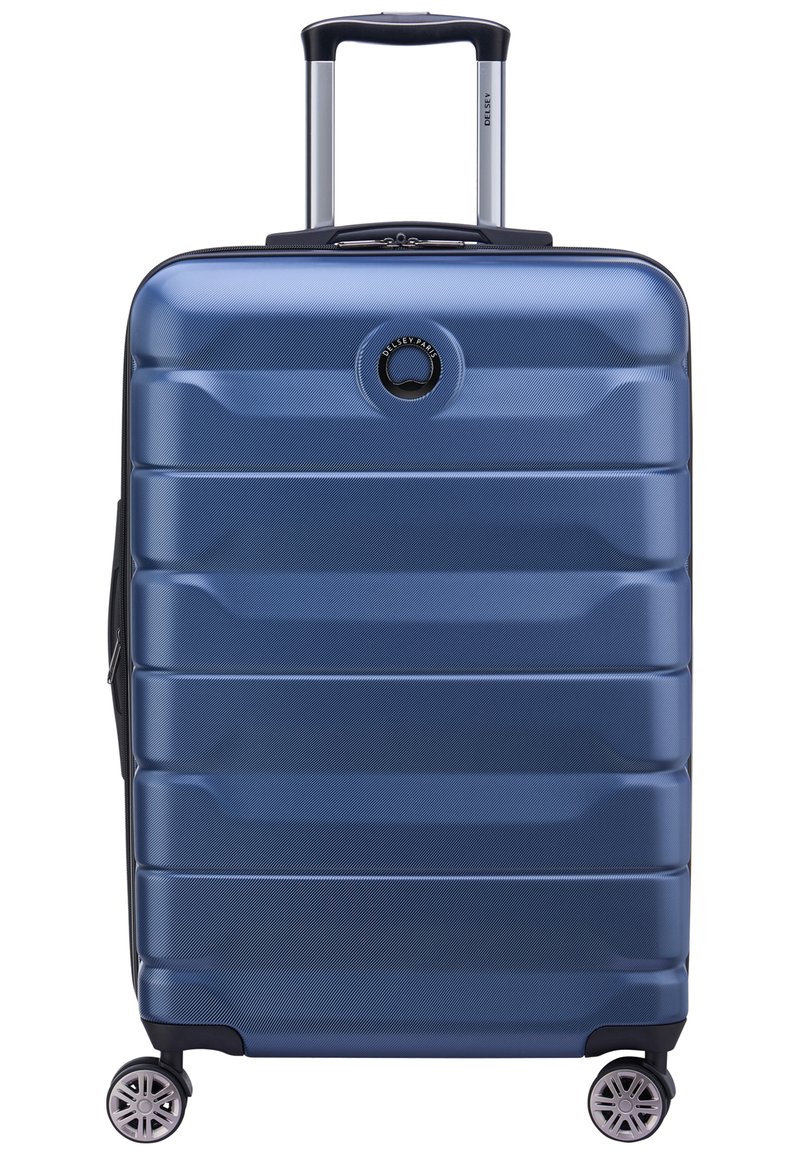 Hartschalenkoffer in Marineblau mit verlängerbarem Teleskopgriff, vier drehbaren Rollen und horizontaler Rillenstruktur.