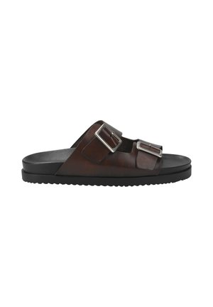 Brown leather slide sandals featuring two adjustable silver buckle straps and a black rubber sole with a textured tread pattern.
