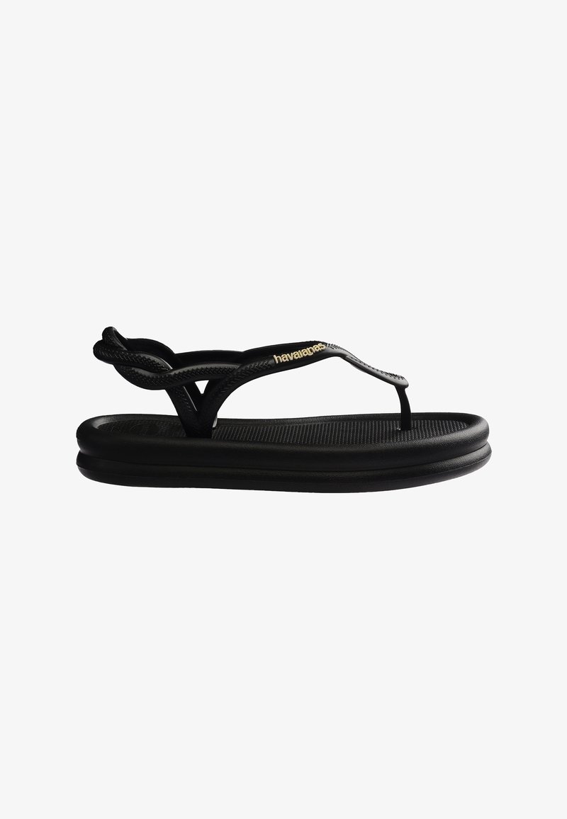 Sandale noire Havaianas avec bride de cheville tressée, design à petit doigt de pied, semelle rembourrée et logo doré sur la bride latérale.