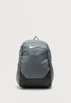 Rucsac Nike gri și negru, cu buzunar frontal, buzunare laterale din plasă, mâner superior și logo-ul alb Nike Swoosh, pe fundal simplu.