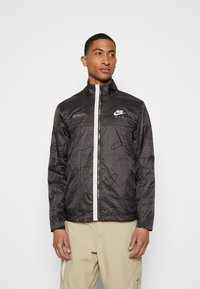 Nike Sportswear Corta-vento - anthracite/light bone