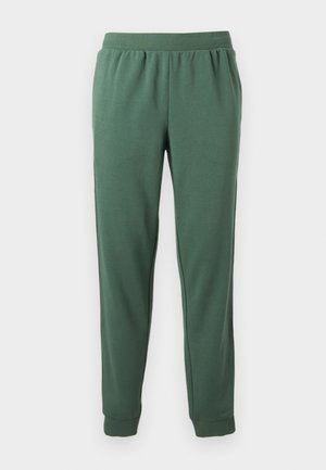 Groene joggingbroek van zacht materiaal, met een rekbare tailleband, zijzakken en geribbelde boorden bij de enkels voor een taps toelopende pasvorm.