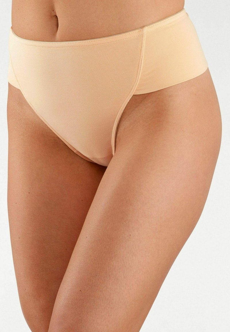 Beige high-waisted ondergoed gemaakt van glad, rekbaar materiaal met een naadloze afwerking en een brede elastische tailleband.