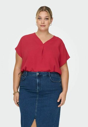 Rød kortermet bluse med V-hals og subtile folder, kombinert med et blått jeans Blyantskjørt med glidelås foran og lommer.