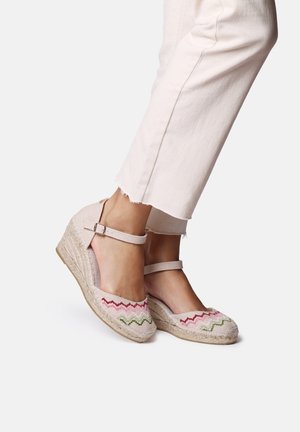 Wedge espadrilles with a beige fabric upper, featuring pink and green zigzag embroidery. Adjustable ankle strap and woven jute sole.