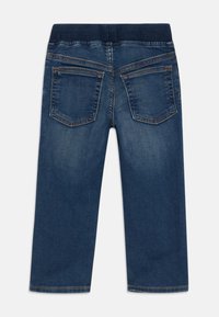 Jeans de mezclilla azul con una cinturilla elástica acanalada, con dos bolsillos traseros y detalles de costura visibles. Diseño de pierna recta.