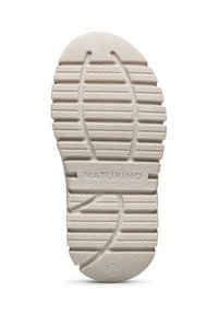 Semelle de chaussure en caoutchouc blanc avec un motif de bande de roulement texturé, comportant des rainures de traction surélevées et le texte "NATURINO" embossé au centre.