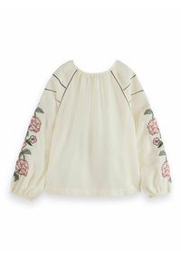 White blouse with long, puffed sleeves. Features floral embroidery in pink and green on the sleeves and black stitched detailing at the neckline.