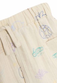 Shorts en coton de couleur crème avec une taille élastique à cordon de serrage. Présente des motifs imprimés multicolores de plantes et d'insectes. Texture douce et légère.