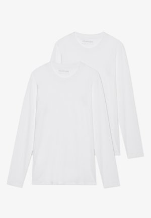 Two plain white long-sleeve crewneck shirts, layered with one slightly in front of the other on a white background.