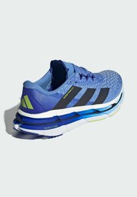Blue athletic shoe with textured mesh upper, black stripes, padded collar, layered sole with blue, white, and green accents.