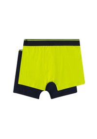 Zwei Paar Boxershorts: eine in leuchtendem Gelb und die andere in dunklem Marineblau. Beide haben kontrastierende schwarze Bündchen und sind aus Baumwolle gefertigt.
