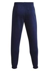 Marineblaue Sweatpants aus weichem Material, mit einem elastischen Bund, schmal zulaufenden Bündchen und einer einzelnen Gesäßtasche. Glatte Textur.