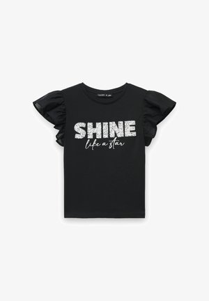 Czarny T-shirt z krótkim rękawem z falbanami z przezroczystej tkaniny. Na przedzie srebrny, brokatowy napis „SHINE like a star”.