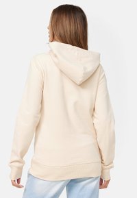 Felpa beige con cappuccio ampio, maniche lunghe e polsini a coste. Texture morbida e vestibilità rilassata, vista posteriore.
