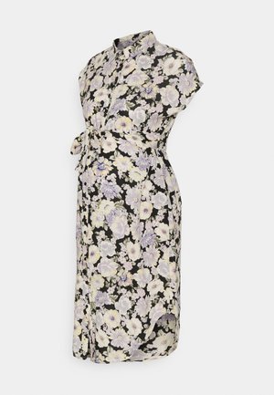 Sort graviditetskjole med kort ærme med hvidt og lavendelfarvet blomsterprint og bælte i stof ved taljen.