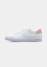 White sneaker with a smooth leather upper, pink accents on the heel and tongue, lace-up design, and a textured rubber sole.