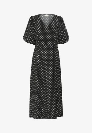 Svart midiklänning med vita prickar, med V-ringning och puffärmen, tillverkad av lätt tyg med en mjuk textur.