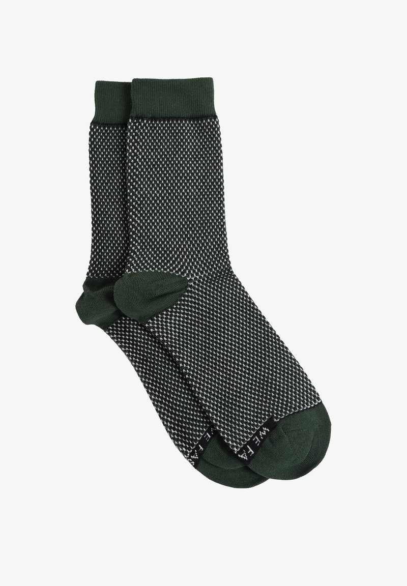 Grå och svarta mönstrade strumpor med en grön ribbad mudd. Designen har ett strukturerat geometriskt mönster på kroppen.