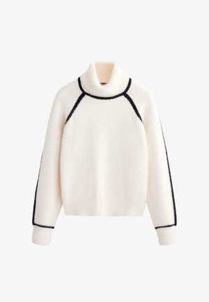 Fehér, bolyhos garbó pulóver fekete díszítésekkel a gallér és az oldalsó varratok mentén. Raglán ujjakkal és laza szabással rendelkezik.