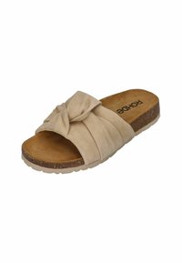 Beige suede slide sandal featuring a knotted accent, cork midsole, and textured outsole for grip. Soft inner lining for comfort.