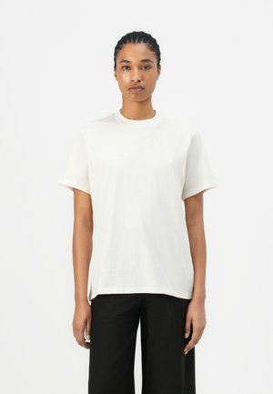 White cotton t-shirt with a round neck and short sleeves, featuring an embossed logo on the left chest. Smooth texture, relaxed fit.