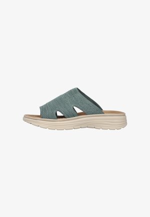 Light blue slip-on sandal with a textured fabric upper, two openings on the sides, and a cushioned cream-colored sole.