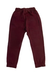 Bordowe spodnie z elastycznym pasem i mankietami przy kostkach leżące płasko, zaprojektowane do noszenia w stylu casualowym, oferujące wygodne dopasowanie i bez widocznych kieszeni.
