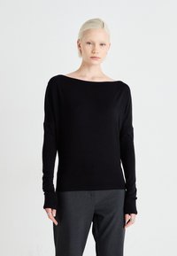 Black long-sleeve top with an off-shoulder neckline and fitted design. Material appears smooth, with extra-long sleeves and minimal detailing.