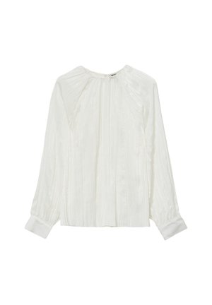 Blouse blanche avec des plis verticaux, un col rond, des manches longues et des poignets boutonnés. Fabriquée dans un tissu léger et lisse.