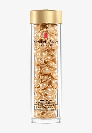 Klar cylindrisk beholder fyldt med guldfarvede kapselserummer mærket Elizabeth Arden Advanced Ceramide Daily Youth Restoring Serum.