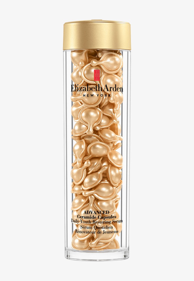 Contenant cylindrique transparent rempli de sérums en capsules de couleur or étiquetés Elizabeth Arden Advanced Ceramide Daily Youth Restoring Serum.