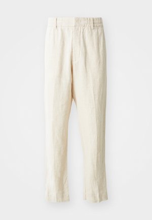 Beige linen trousers with a loose fit, tapered legs, and a flat front. Features an elastic waistband for comfort and minimal seam detailing.
