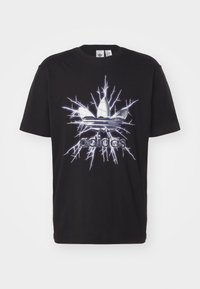 Black cotton t-shirt featuring a large graphic of the Adidas logo surrounded by a lightning bolt design in white and blue.