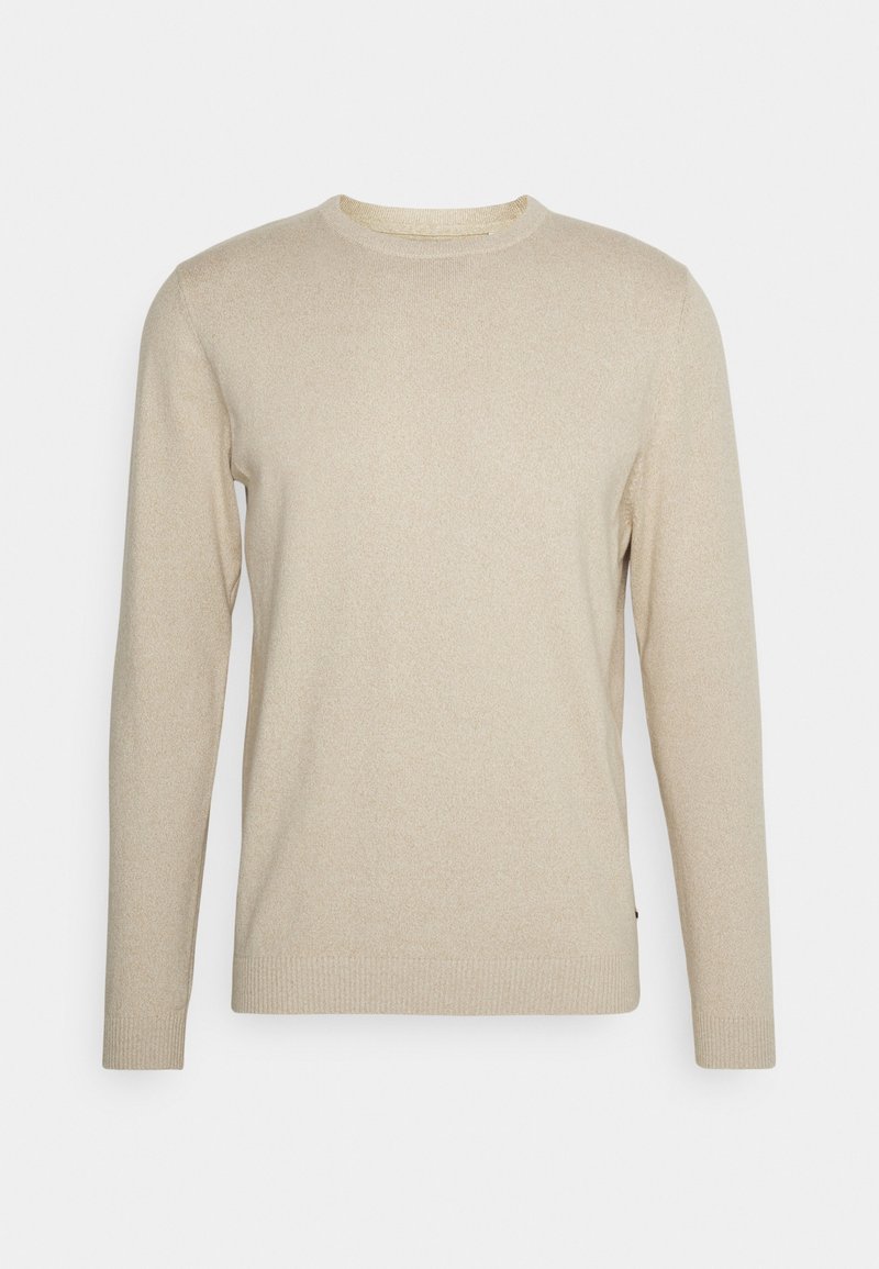 Pull en tricot beige avec un col rond, des manches longues et des poignets côtelés. Texture douce avec un motif discret. Pas de pièces métalliques ou d'accents visibles.