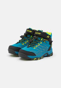 Hi-Tec hiking boots in blue and black, featuring yellow accents, a textured upper, and laces with a quick-pull function.