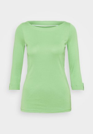 Light green, long-sleeve women's top with boat neckline and cuff details on sleeves, displayed on plain background.