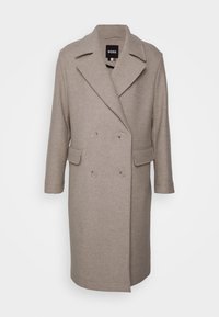 Manteau en mélange de laine beige avec un design à double boutonnage, des revers à crans, des poches latérales et une coupe décontractée. Texture lisse et longueur mi-mollet.