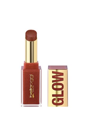 Rossetto in una tonalità rossa scintillante con tubo dorato e base rettangolare rossa scintillante, accanto al suo tappo dorato con etichetta "GLOW".