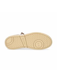 Semelle d'une sneaker avec un fond en caoutchouc beige texturé, comportant un design circulaire et en flèche, étiqueté "SUN68", et des motifs de crampons en zigzag.