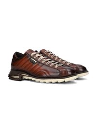 Brown leather shoes with textured finish, featuring cream-colored soles and distinctive lacing system. Accentuated by branded hardware.