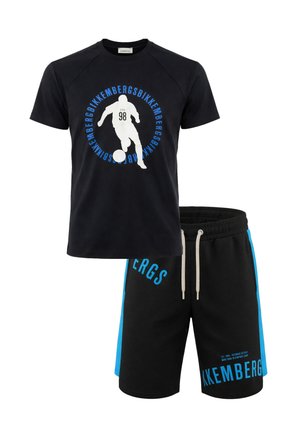 T-shirt nera a maniche corte con grafica bianca di un calciatore e scritta blu "Bikkembergs", abbinata a pantaloncini neri con strisce laterali blu e logo.